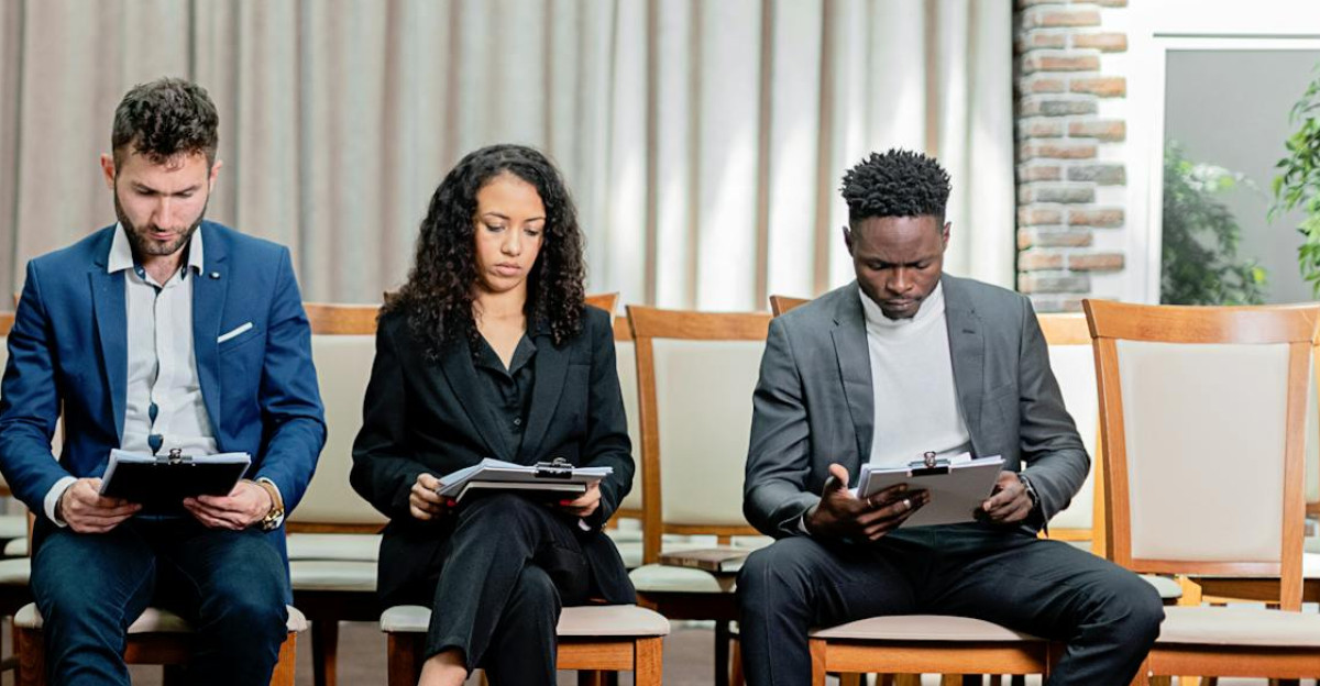 A diverse group of professionals attentively reviewing documents indoors