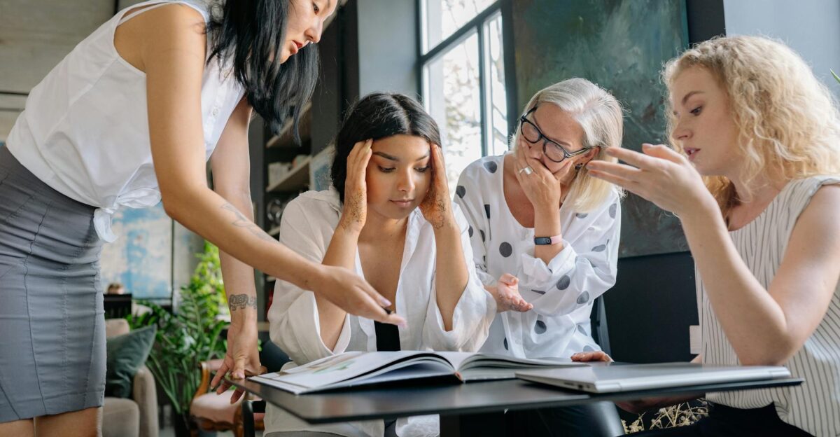 Group of women in a modern office environment collaborating on a project together