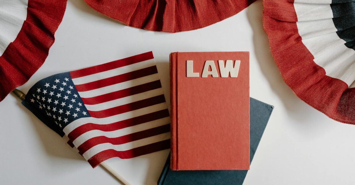 American flag with a law book symbolizing independence and politics