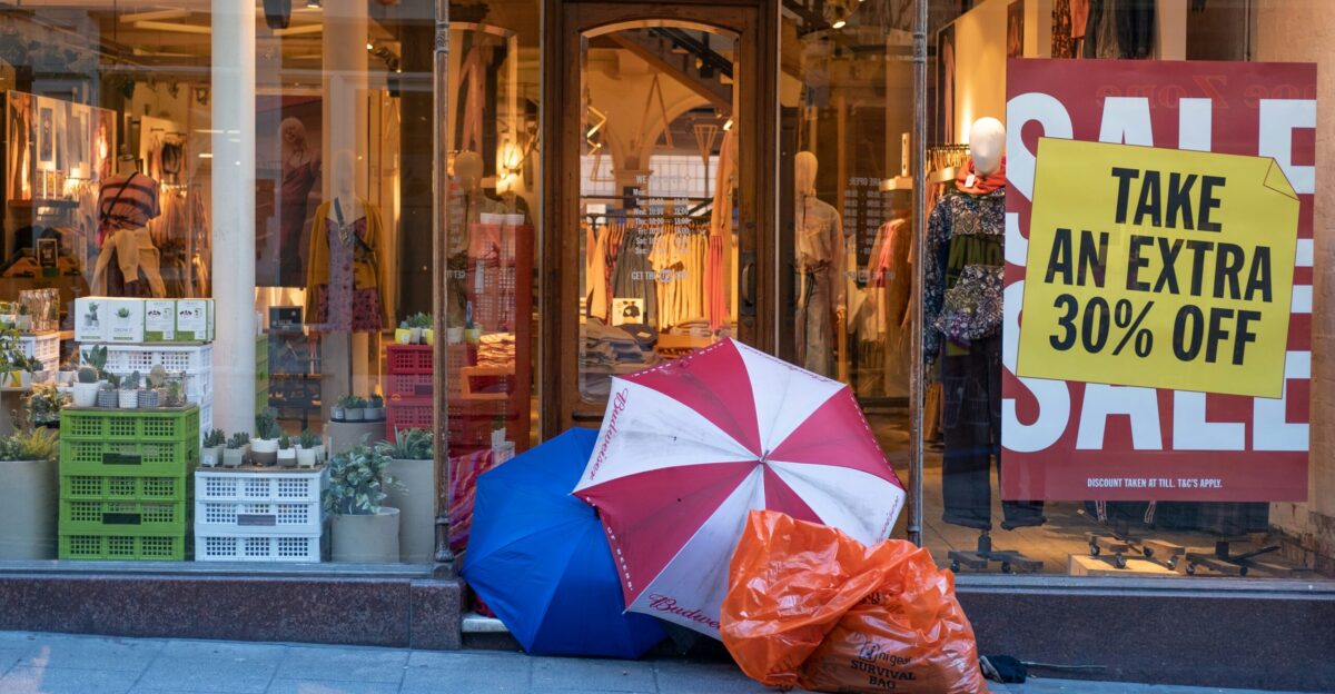 red and white umbrella beside plastic bag