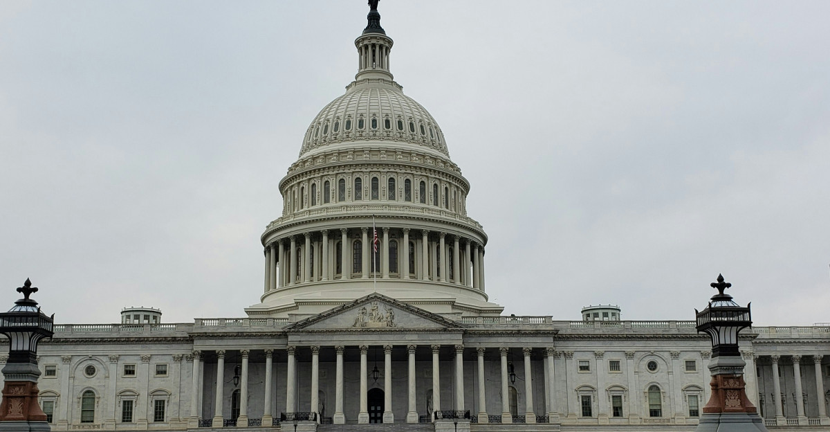 people walking on street near white concrete building during daytime