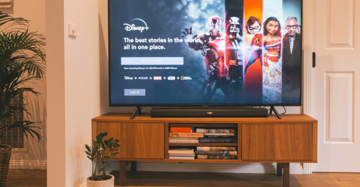 black flat screen tv turned on on brown wooden tv rack