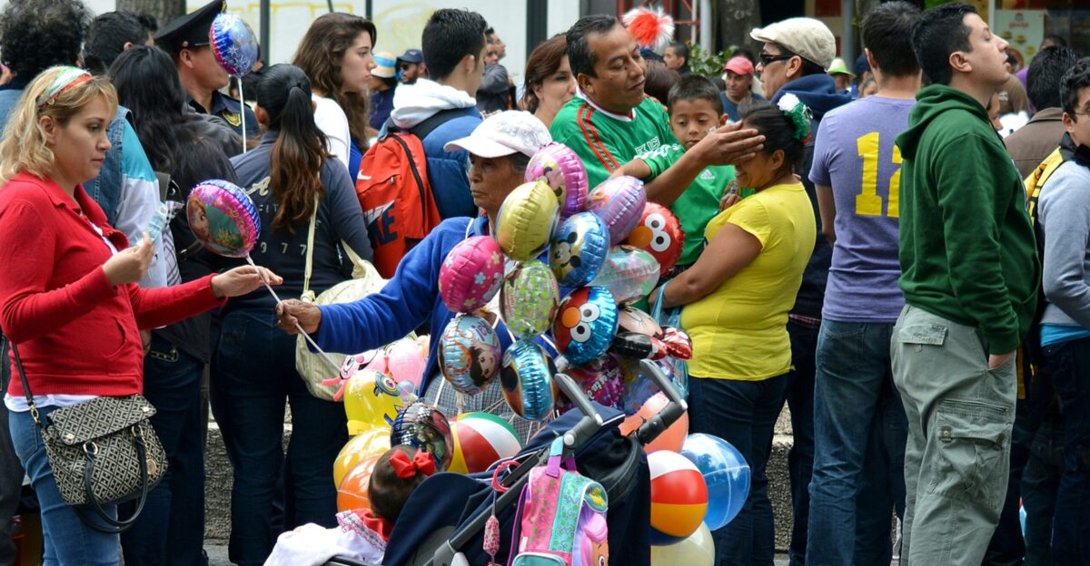 people standing and carrying balloons during daytime