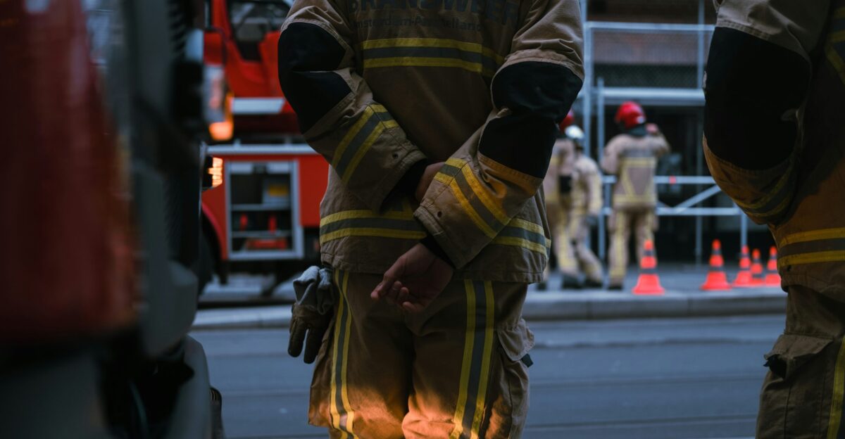 man in yellow and black camouflage jacket walking on street during daytime