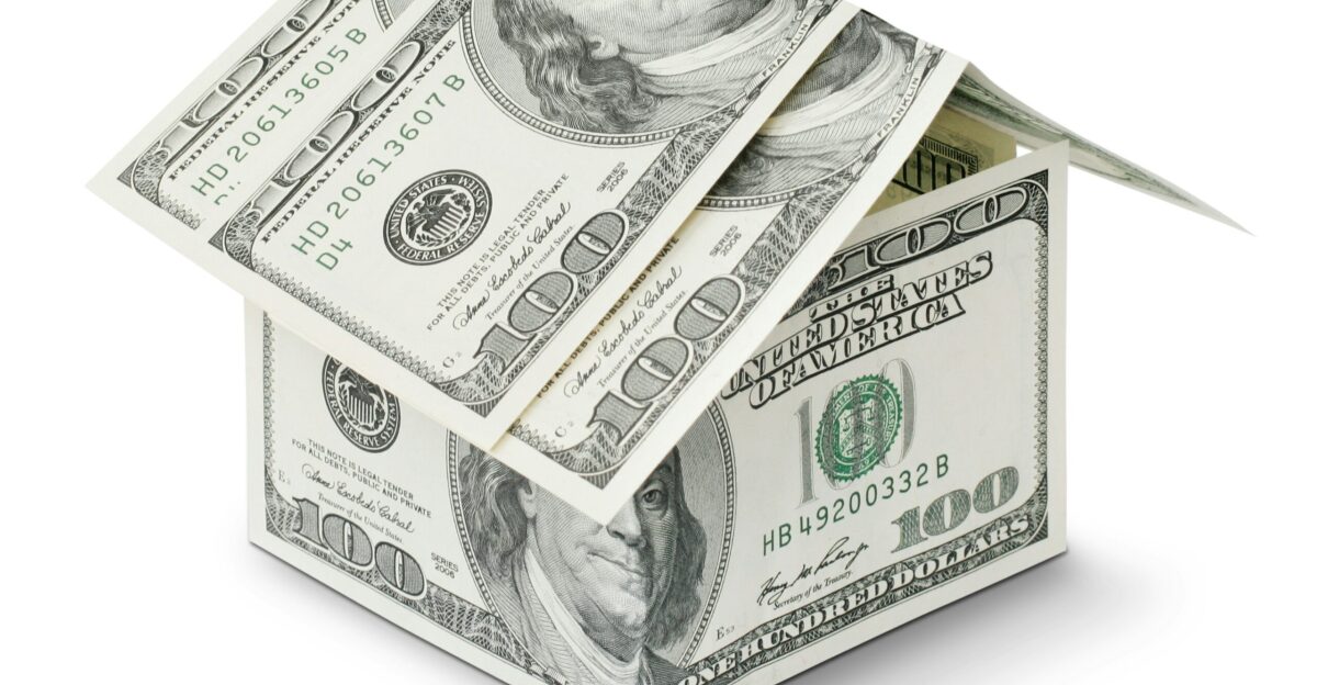 a house made out of money on a white background