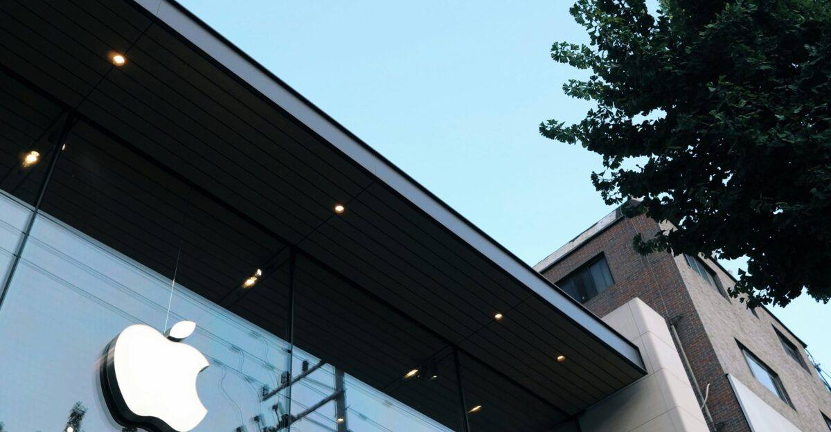 an apple store with a tree in front of it