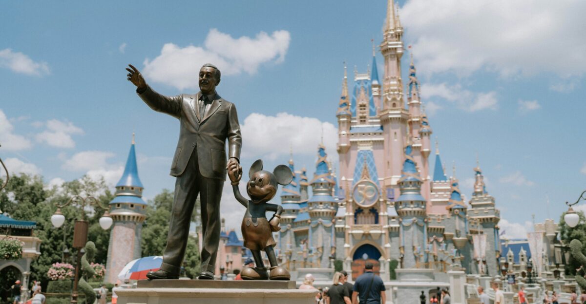 a statue of a man in front of a castle