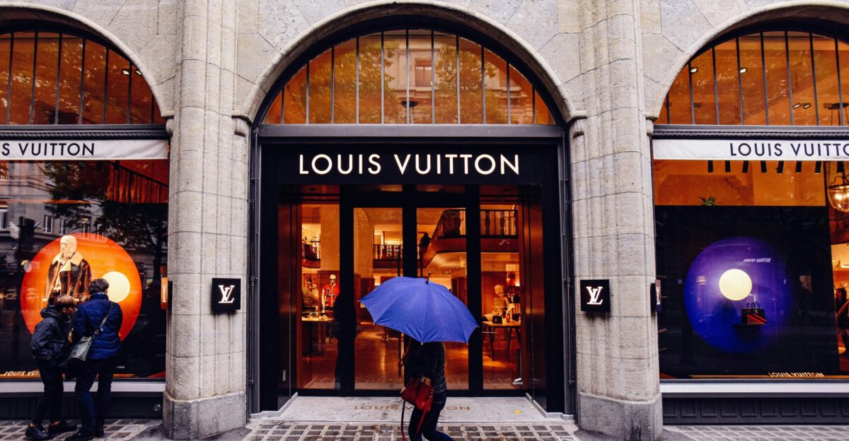a person walking down the sidewalk with an umbrella