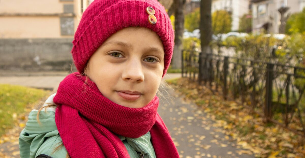 a girl wearing a red hat and scarf