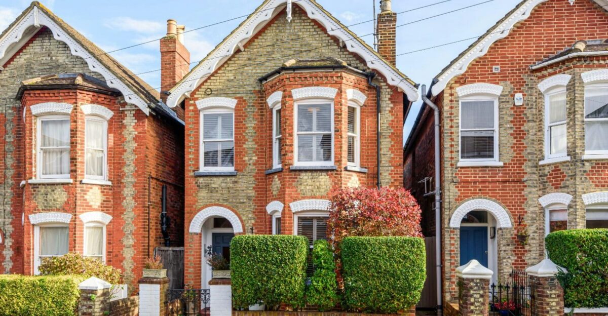 a row of brick houses with white windows