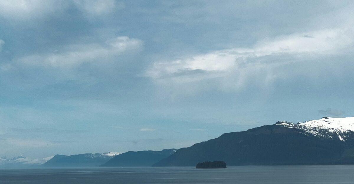 a large body of water with mountains in the background