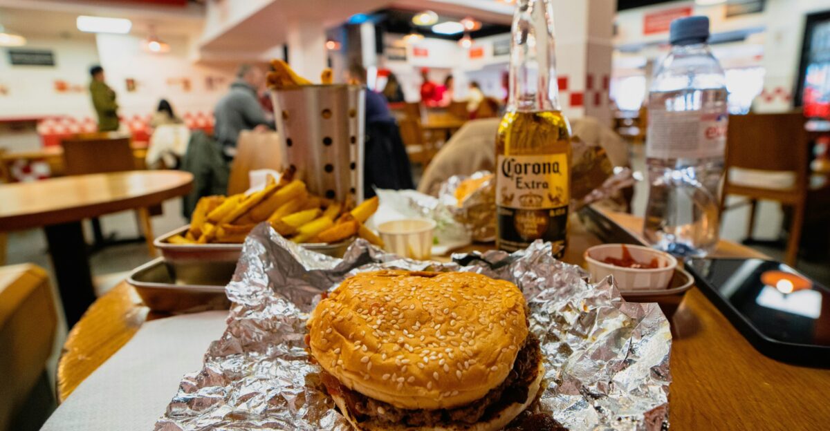 a hamburger sitting on top of a table covered in tin foil