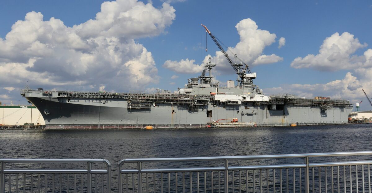 a large military ship docked in the water