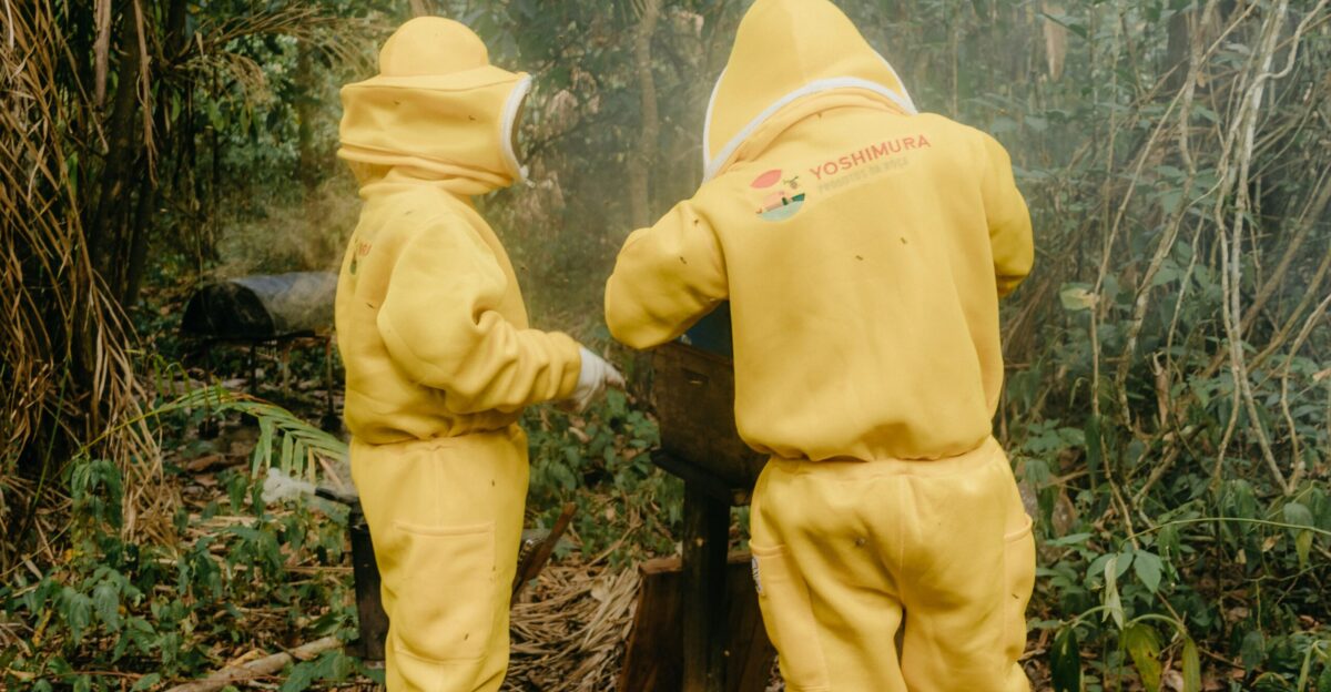 a couple of people in yellow suits standing next to a fire hydrant