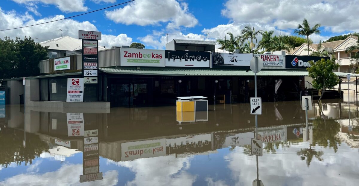 a flooded street in front of a store