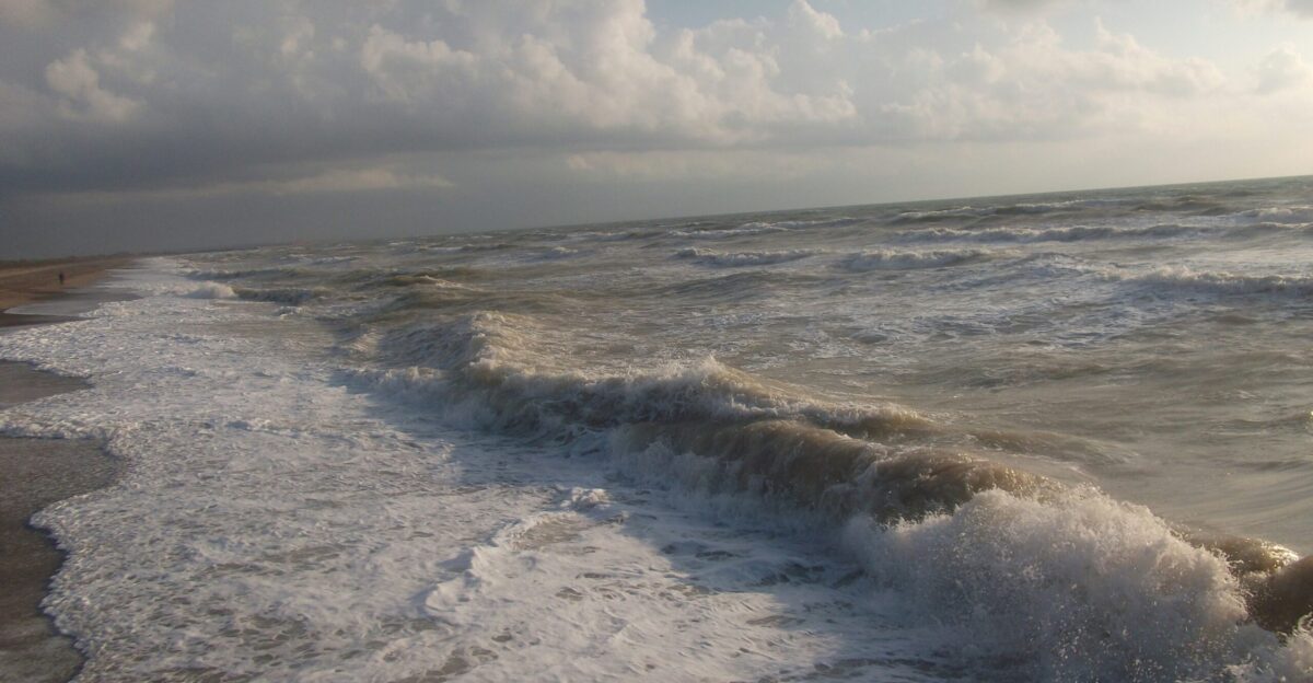 a beach with waves coming in to shore