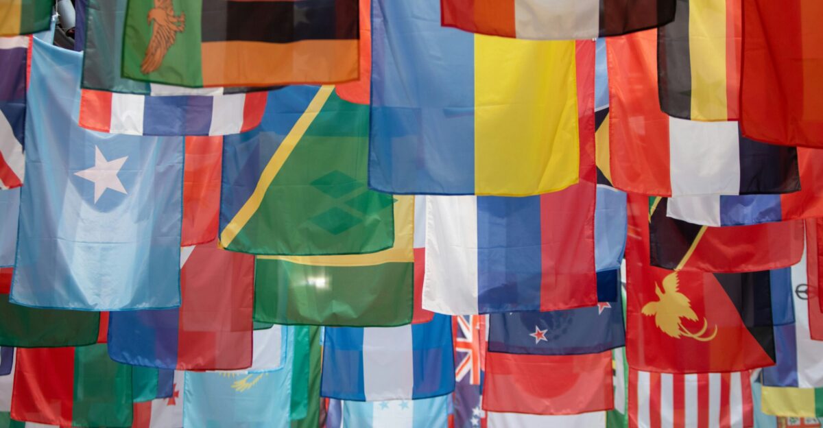 a bunch of flags hanging from a pole