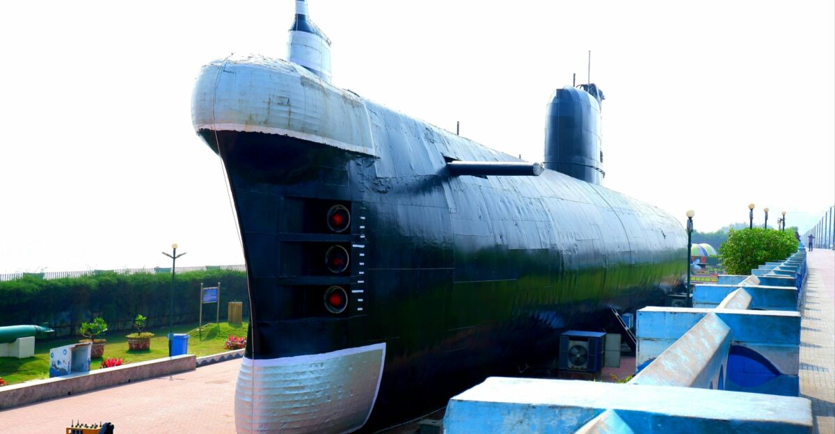 a large black submarine sitting on top of a sidewalk