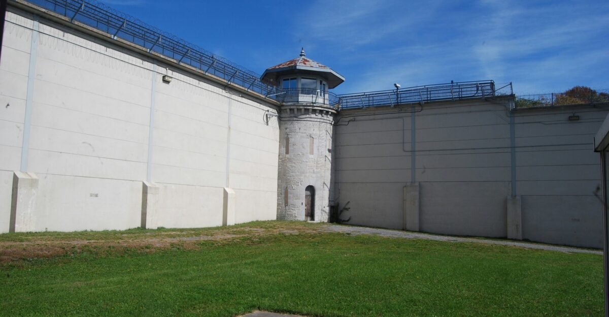 a tall white tower sitting next to a building