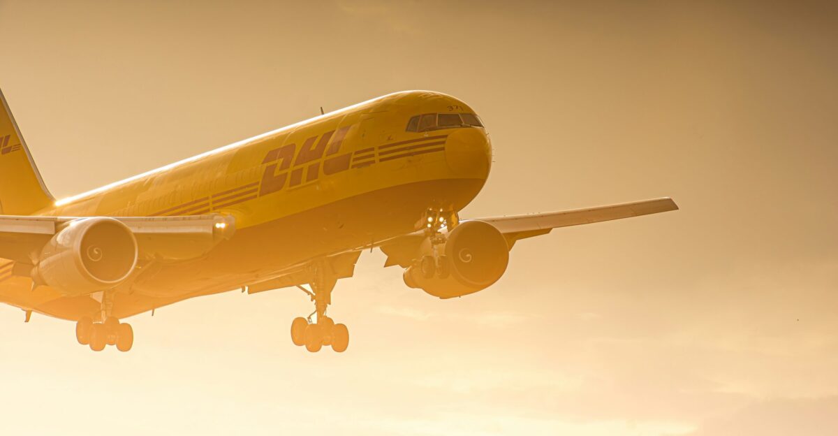 a large jetliner flying through a cloudy sky