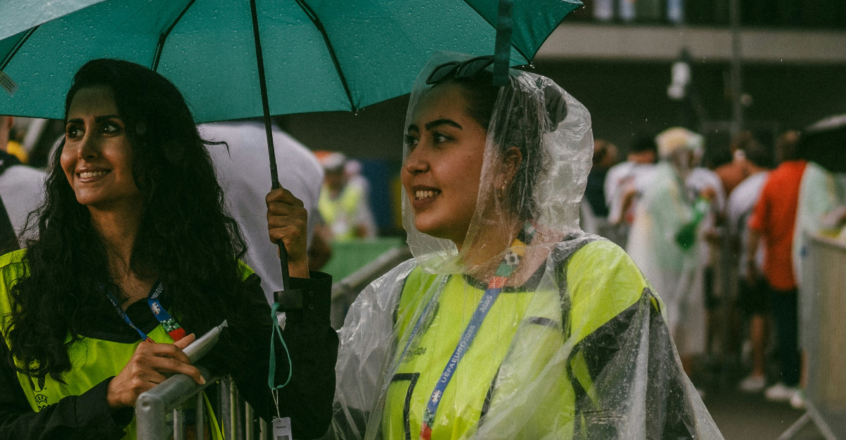 A couple of people that are standing under an umbrella