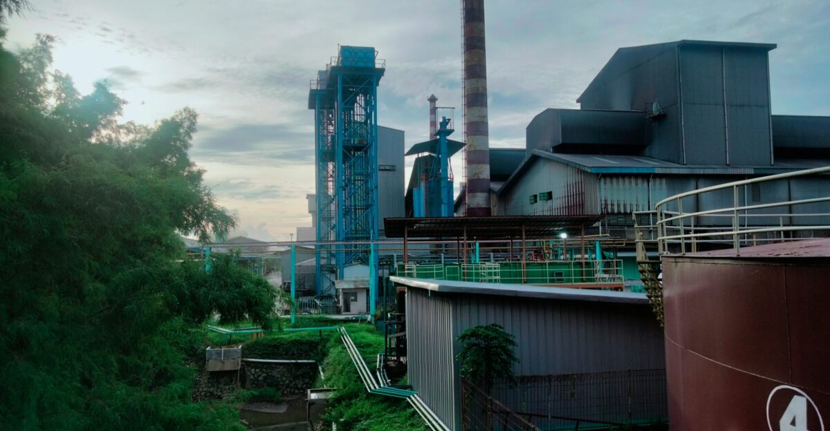 A factory with smoke stacks in the background