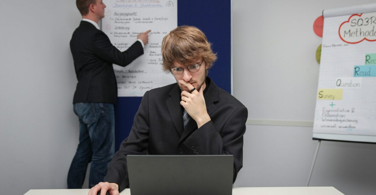 A woman sitting at a desk with a laptop computer