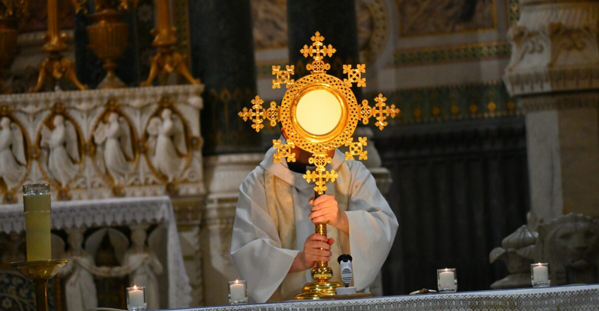 A person holding a cross in a church