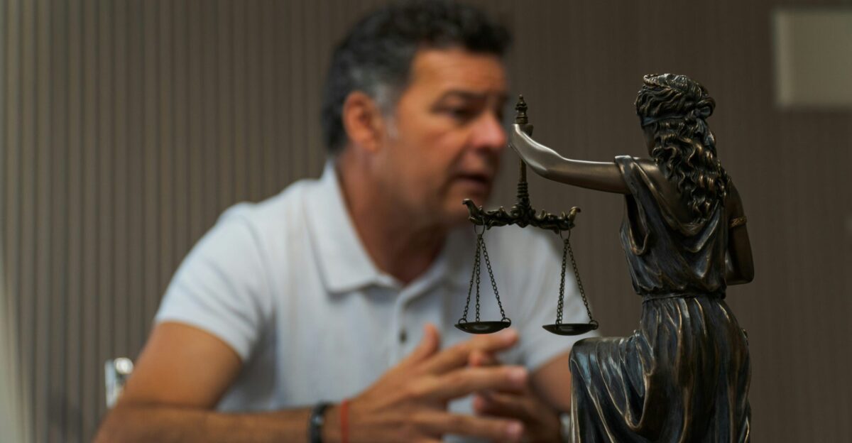 A man sitting at a table in front of a statue