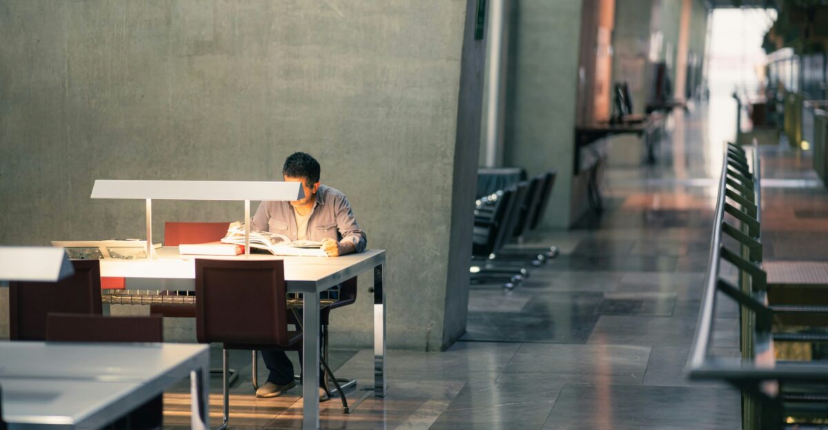 A person sitting at a table with a laptop