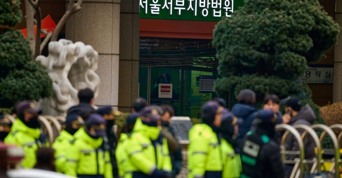 A group of police standing in front of a building