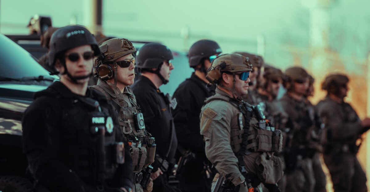 Heavily armed police officers standing in a line