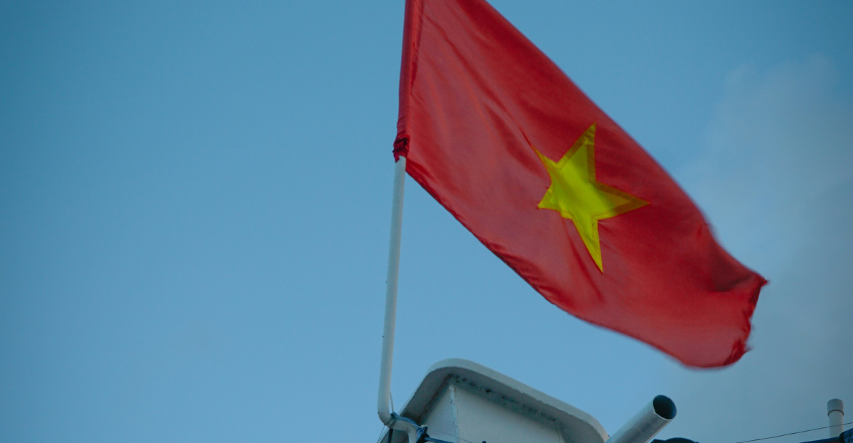 The vietnamese flag waves proudly in the sky.
