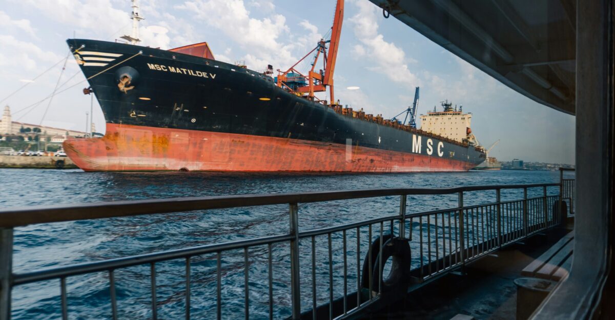 A large cargo ship cruises on the ocean