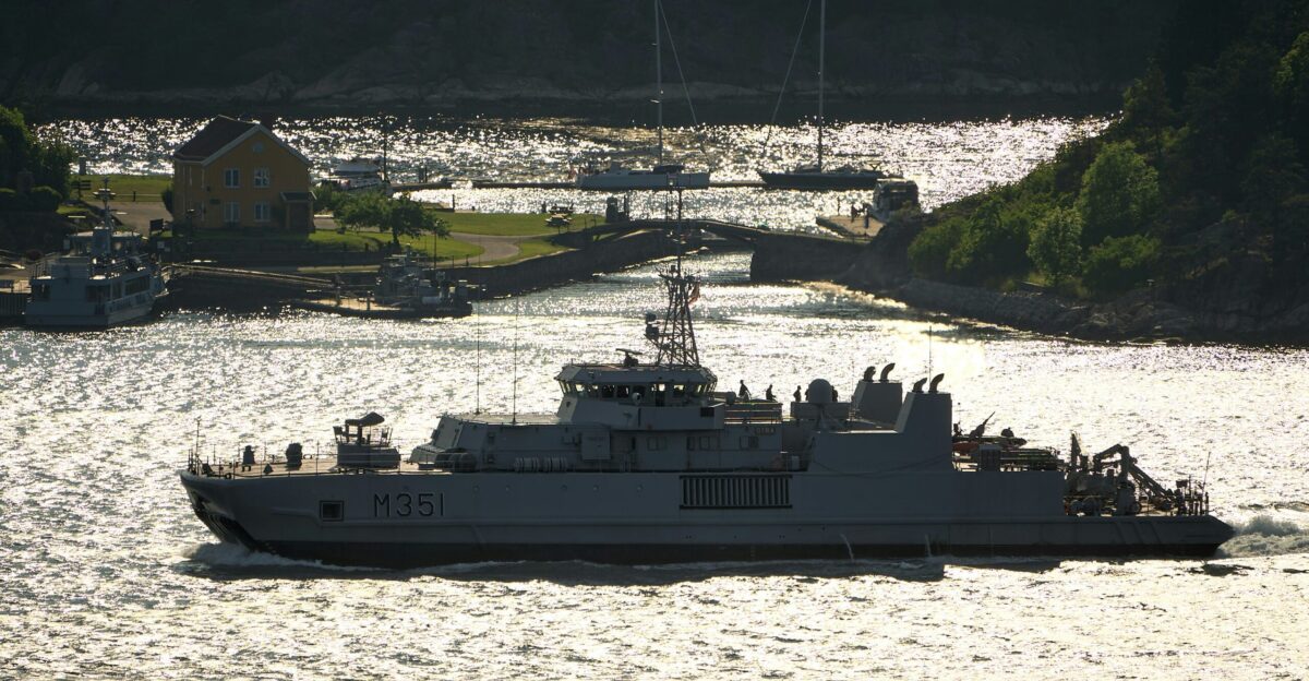 A military ship cruises through the water