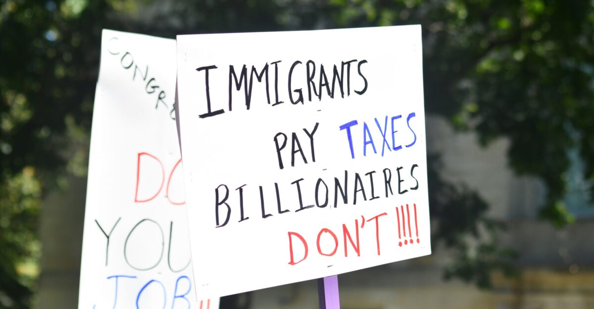 Protest signs about taxes and jobs