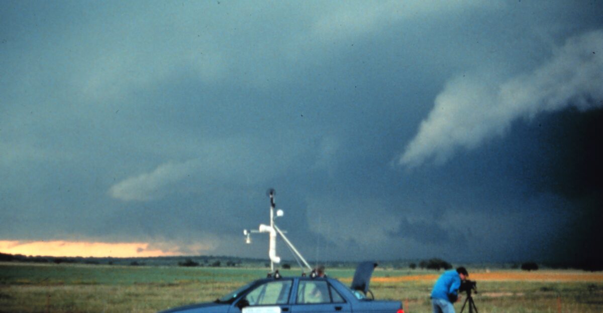 A member of NOAA s National Severe Storms Laboratory films a potentially tornadogenic storm in Graham Texas during the first VORTEX project