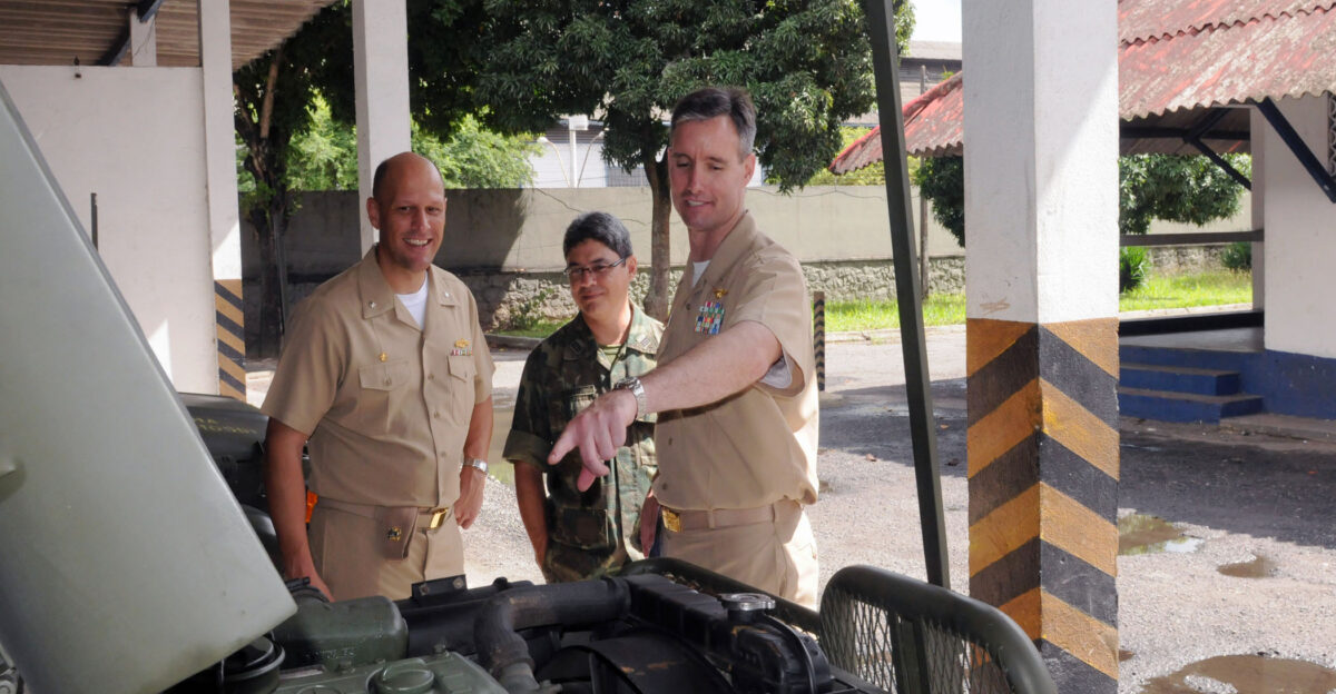 SALVADOR Brazil April 29 2010 Cmdr Scott M Smith commanding officer of the guided-missile frigate USS Klakring FFG 42 Cmdr Terrence Dudley of the Navy Section Chief Military Liaison Office Brazil with Capitao de Fragata CF Fabio Carrancho da Silva Rocha Commander of the Fuzileiros Navais looks at the engine of a transport vehicle after the 67th Anniversary celebration of the Brazilian Marines in Salvador Klakring is on a six-month deployment to Latin America and the Caribbean as part of Southern Seas 2010 a U S Southern Command-directed operation that provides U S and international forces the opportunity to operate in a multi-national environment U S Navy photo by Mas Communication Specialist 1st Class Michael J Scott Released