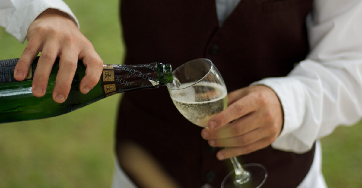 Wine service pouring a glass of the Italian sparkling wine
