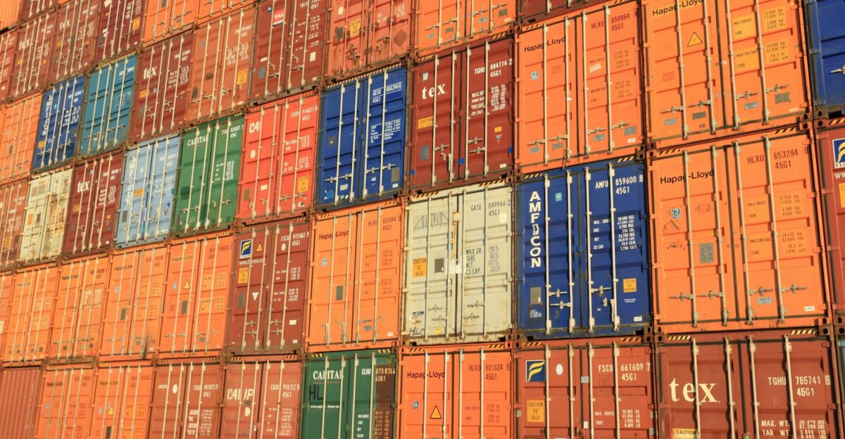 Colorful shipping containers stacked in a harbor symbolizing global trade
