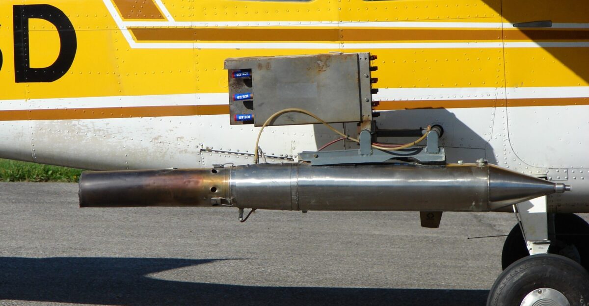 Cessna 206 rebuilt for cloud seeding with detail view of silver iodide generator