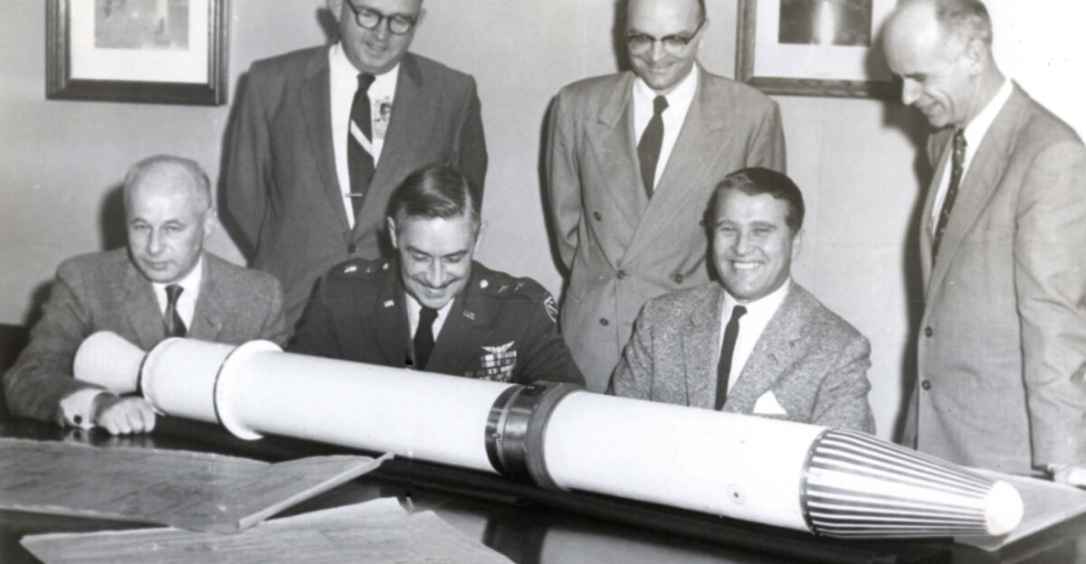 EXPLORER I briefing Shown with a model of the Jupiter-C rocket Explorer 1 satellite are seated Dr Eberhard Rees General Edmond O Connor and Dr Wernher Von Braun Standing to Dr Von Braun s right is Dr Ernst Stuhlinger