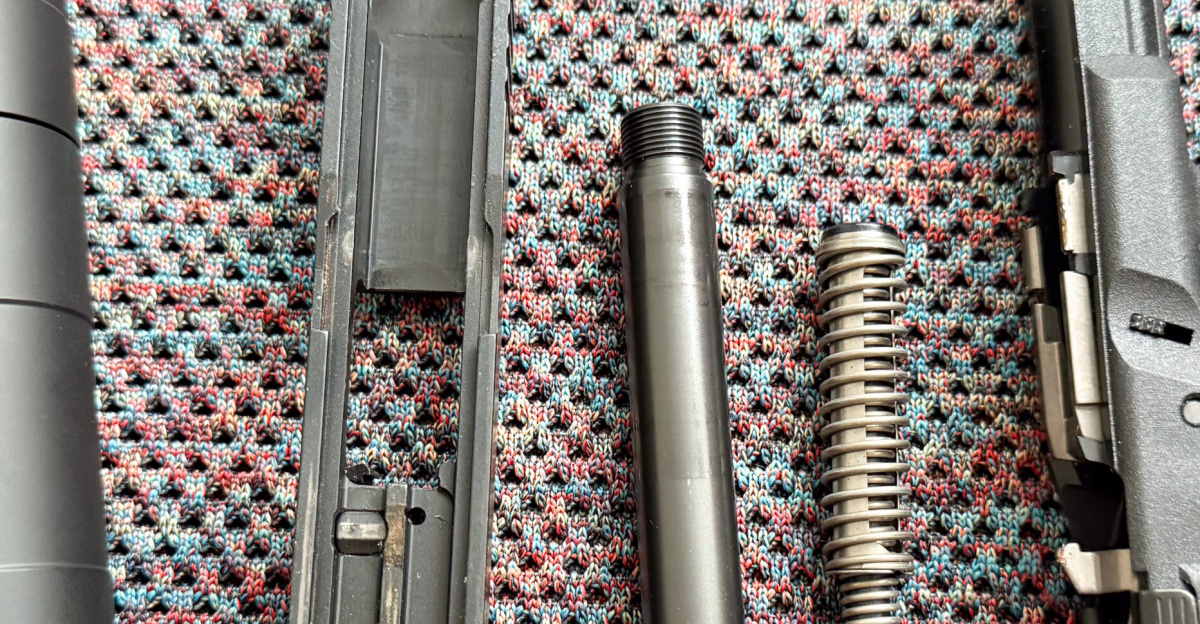 Disassembled Glock handgun and silencer