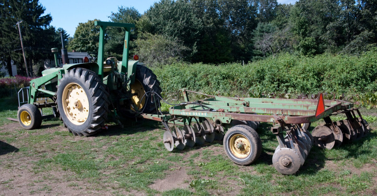 John Deere tractor with JD FEL and a John Deere disk harrow