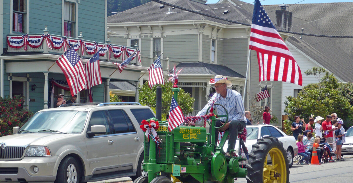 City Councilman John Maxwell pilots his vintage John Deere Tractor in the U S Independence Day Parade in Ferndale California