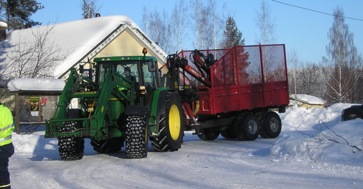 A John Deere tractor with a John Deere 731 front loader and a PATU log loader trailer in Jyv skyl Finland