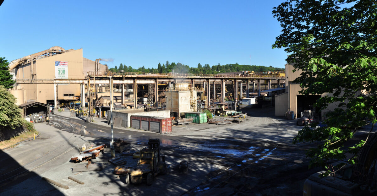 Panoramic view Nucor Steel Seattle from Avalon Way SW just south of SW Spokane St Seattle Washington U S The black triangle at upper left is the viaduct of the West Seattle Freeway running above Spokane Street