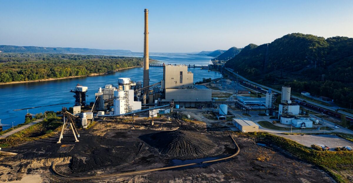 Aerial view of an industrial facility by a river in Genoa WI showcasing environmental impact