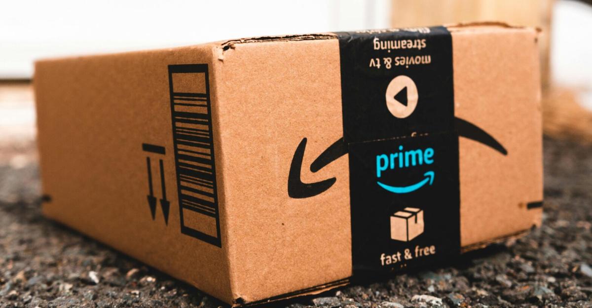A cardboard box marked with Prime logo placed outside on a porch, ready for delivery.
