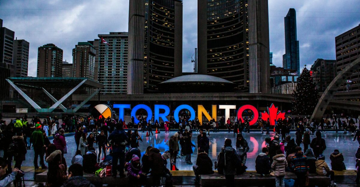 Vibrant evening at Toronto City Hall with festive crowd enjoying the cityscape